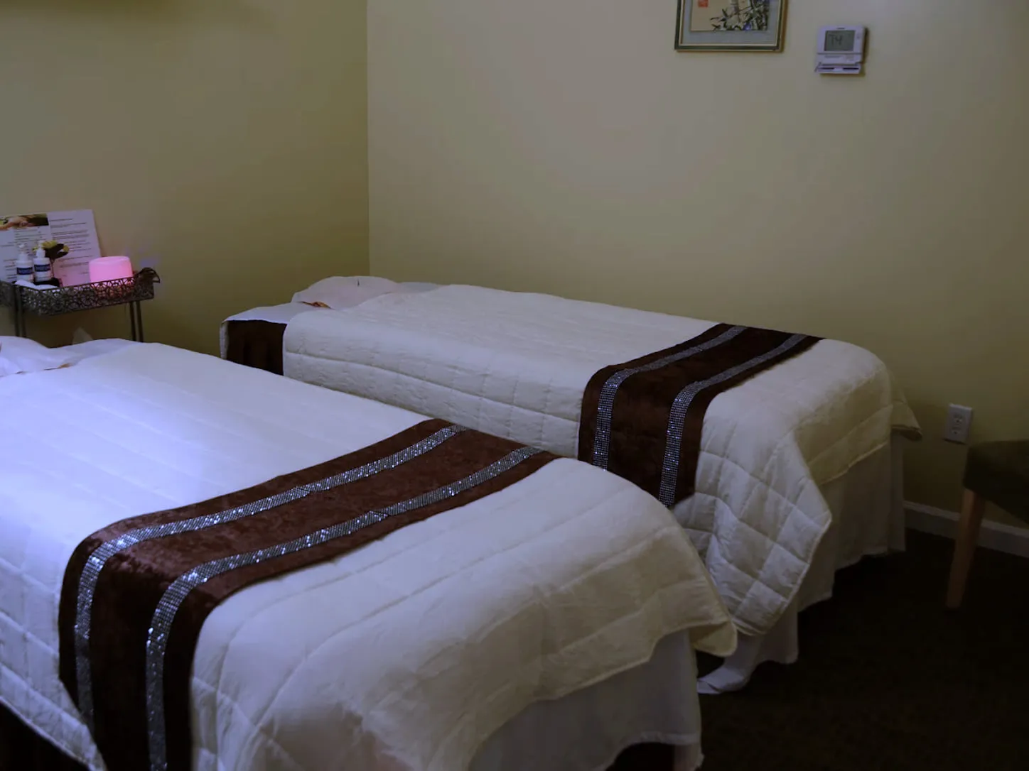 The couples room at LJY Reflexology, with two massage tables made up side by side in white quilted covers